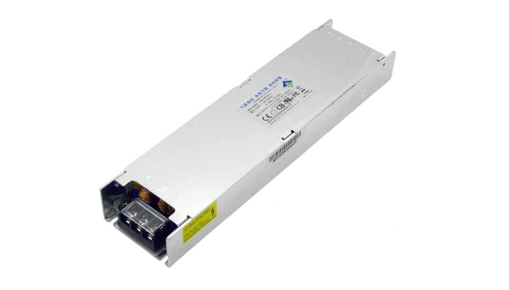 Rectangular metal industrial power supply module with exposed connector and a yellow caution label on the side.
