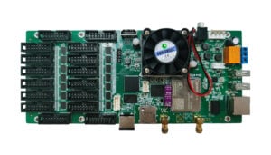 Green development board with many expansion sockets, a central fan, and multiple I/O ports.