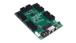 Green development board featuring multiple 40-pin header connectors around the edges and an Ethernet port, with USB and power components visible.