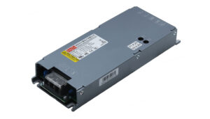 Metal rectangular DC power supply with input/output terminal block on the front and warning labels on top.”