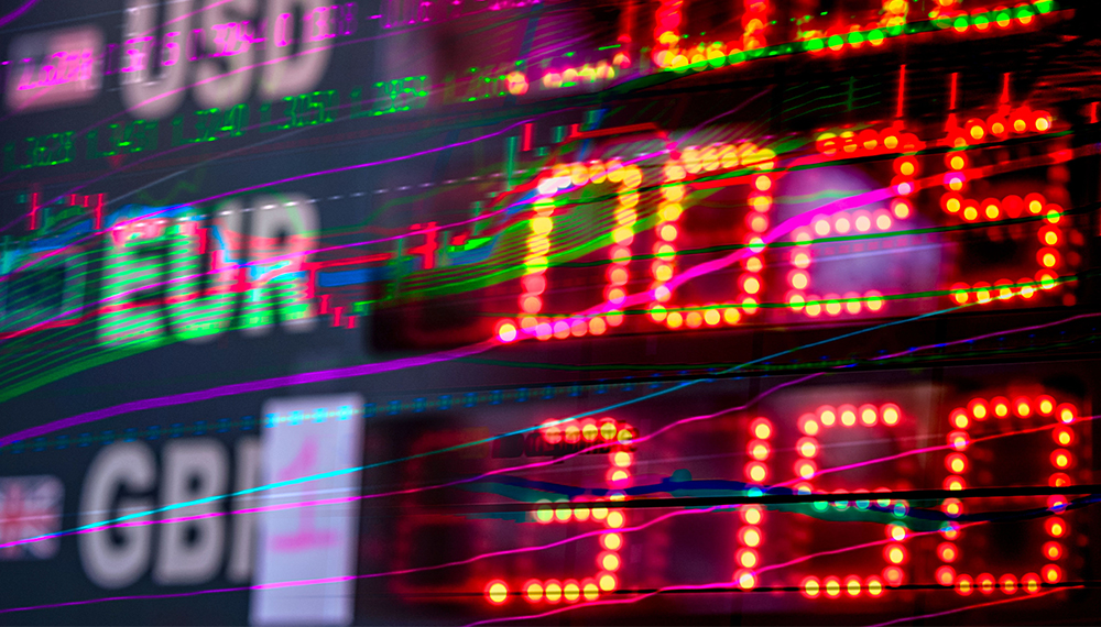 Blurred stock ticker with bright red LED numbers and neon green/blue graphs across the frame, conveying market activity.
