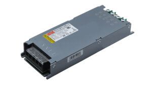 Industrial DC power supply module with a screw-terminal block on one end and warning label on top