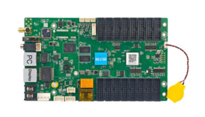 Green multi-socket development board with many plug-in headers and a yellow battery connector on the right.