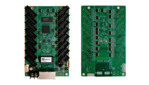 Two green PCBs laid side by side with many header pins; left board shows a USB port and power terminals, right board backsides with solder pads.